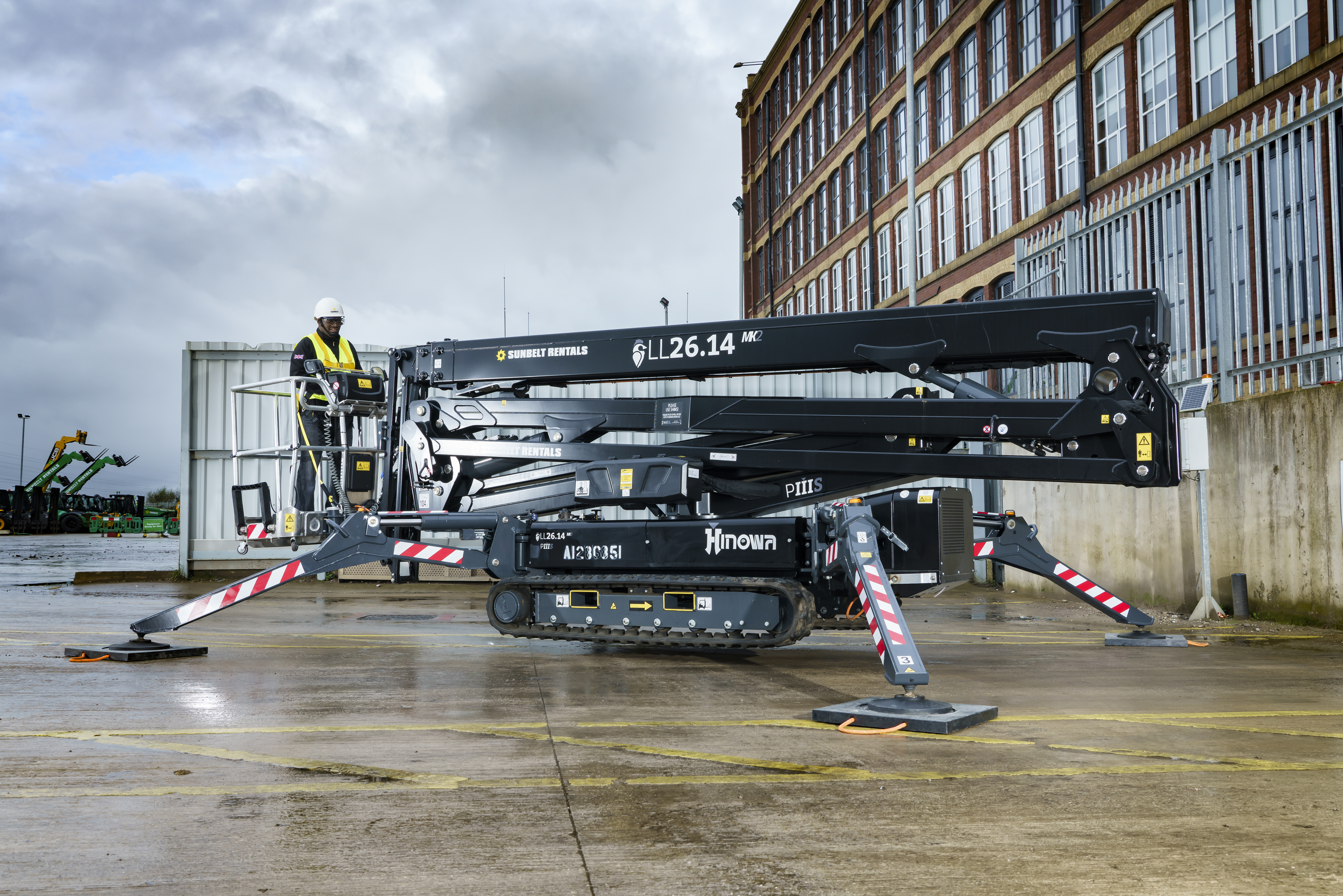 a black tracked access equipment on an open lot