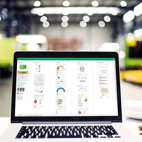 A laptop screen shows a telematics dashboard of equipment on hire from Sunbelt Rentals