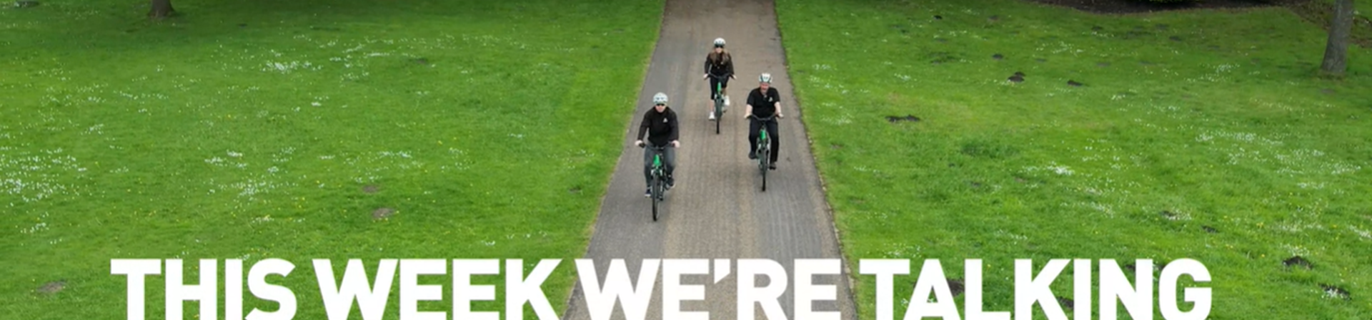 'This week we're talking health and wellbeing' text lay over image of three cyclists cycling on a park path surrounded by a field 