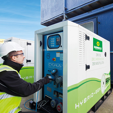 Sunbelt Rentals engineer plugs a cable into a hired hybrid generator