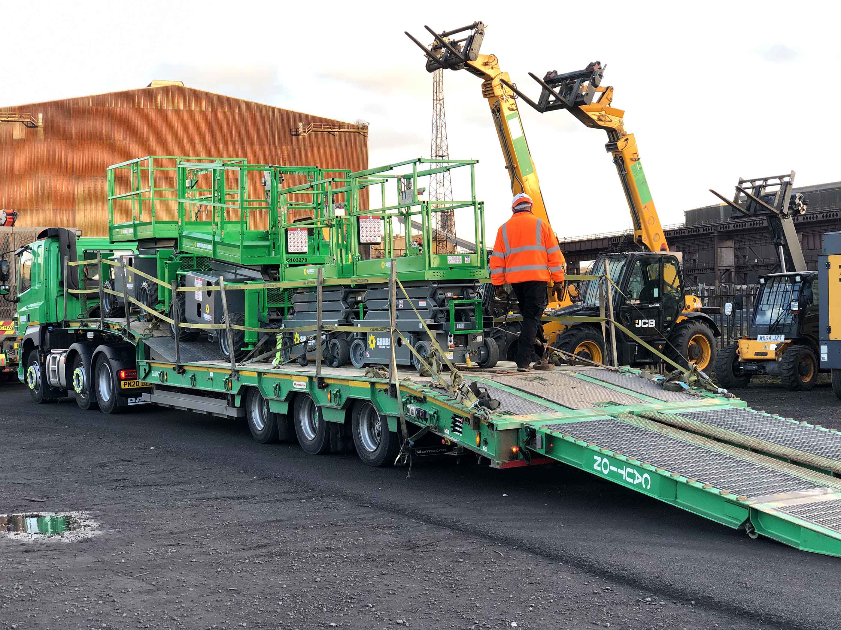 Powered Access Scissor Lifts Loaded Onto The Back Of A Flatbed