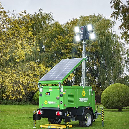 A Sunbelt Rentals Solar Battery Tower Light Illuminated In A Park