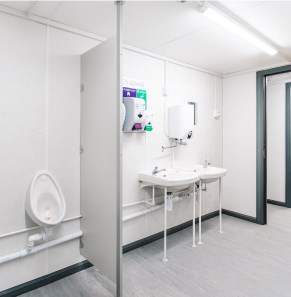 white interior of a toilet & shower cabin unit