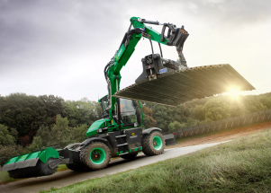 Sunbelt Rentals green plant equipment lifting Trakway ground protection panel into place
