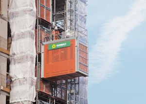 Orange Sunbelt Rentals passenger hoist on side of building under construction