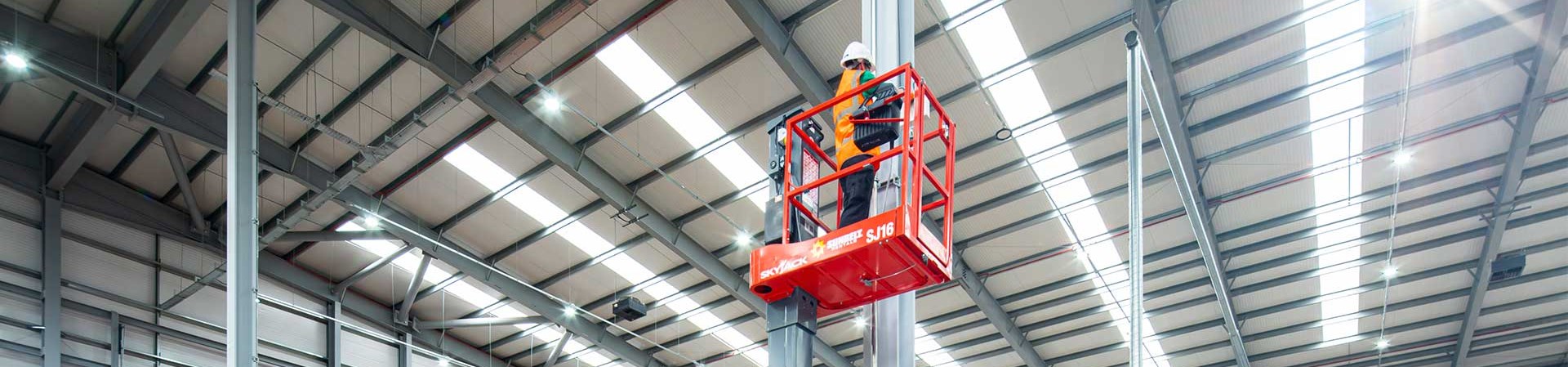 Man Standing On Low Level Access Platform On Site At A Sigma Retail Solutions Location In Warehouse
