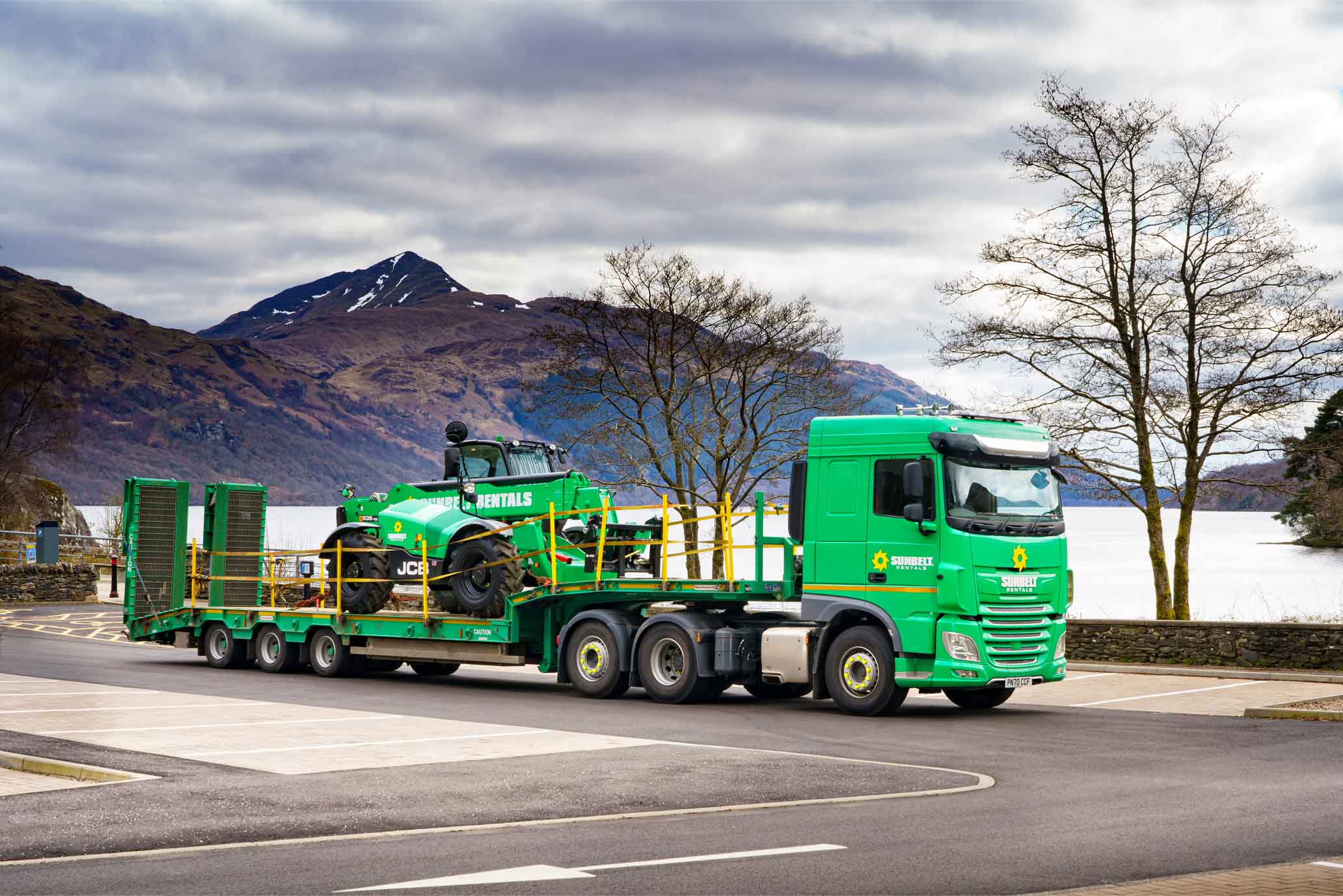 Sunbelt Rentals Truck Loaded With Telehandler In View Of Loch Lomand