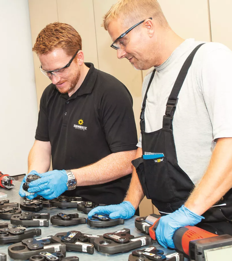 Sunbelt Rentals employees working next to table with equipment