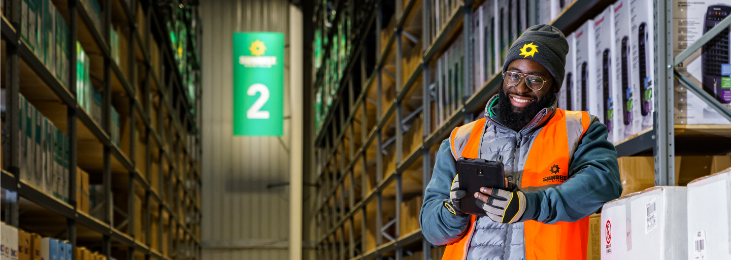 Product Sales Warehouse Operator Checking Orders On iPad  