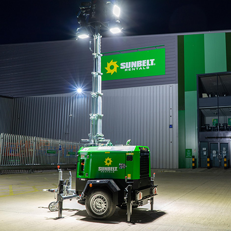 A Sunbelt Rentals Eco Tower Light Illuminated Outside Of A Depot