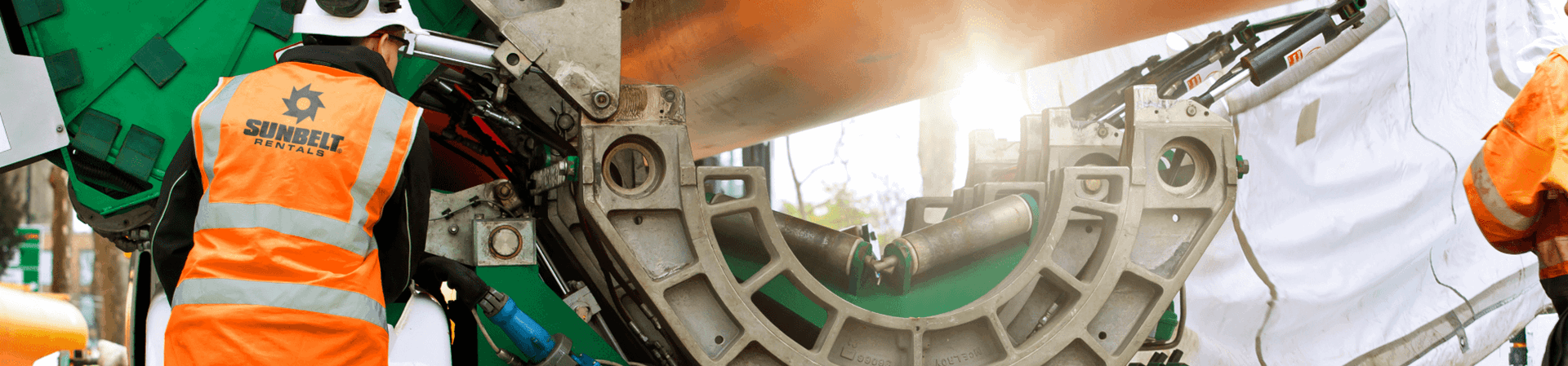 Sunbelt Rentals employee working on utilities pipes