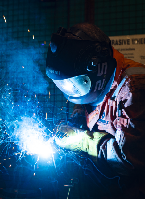 Sunbelt Rentals employee welding while wearing welding mask and protective clothing