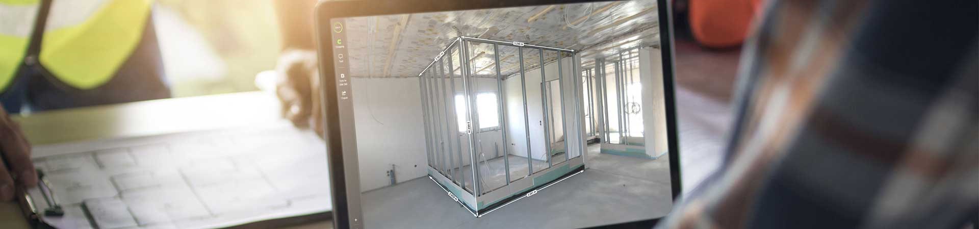 Project Manager On Site Using A Digital Project Solution At A Table