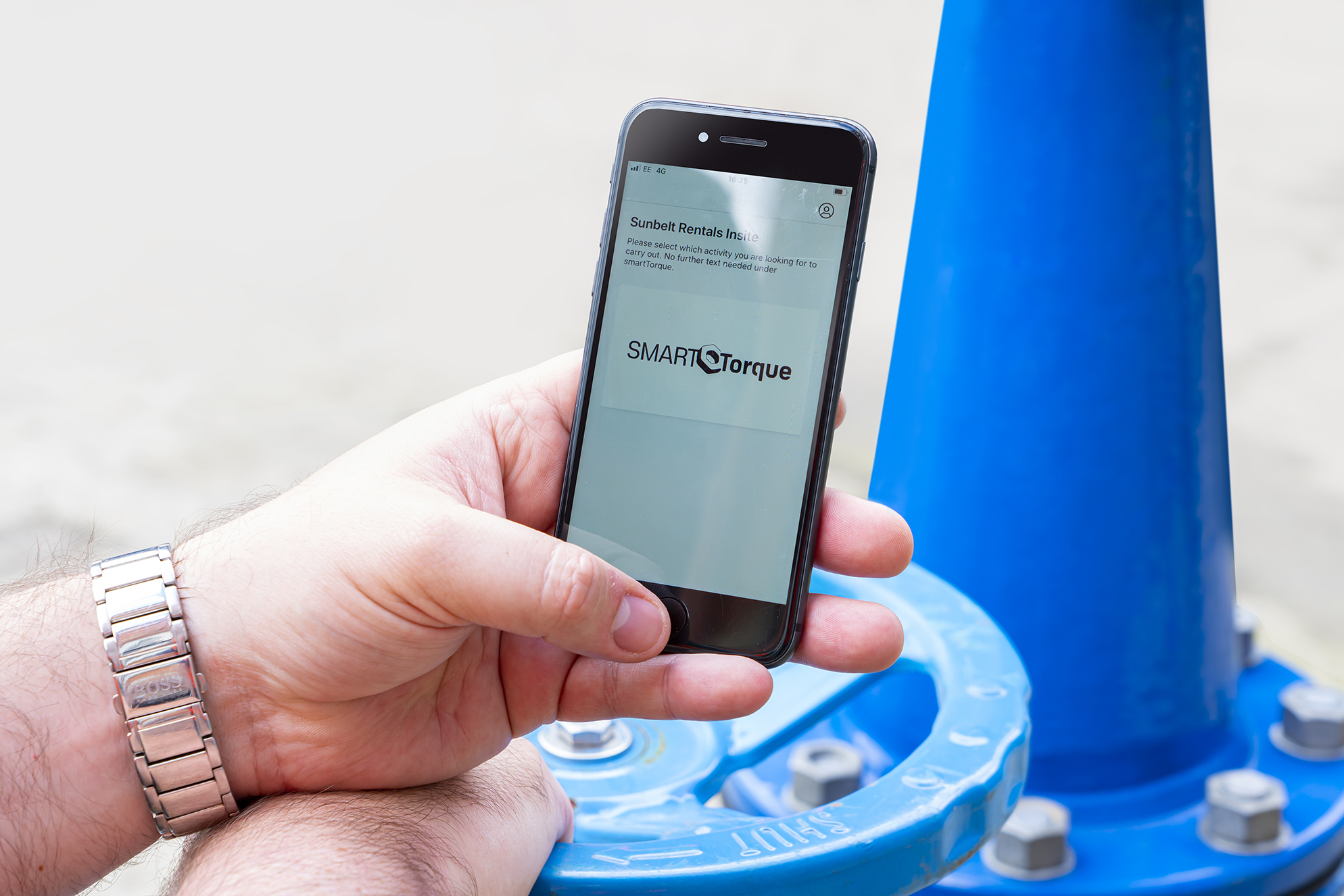 person holding mobile phone using Smartsite app