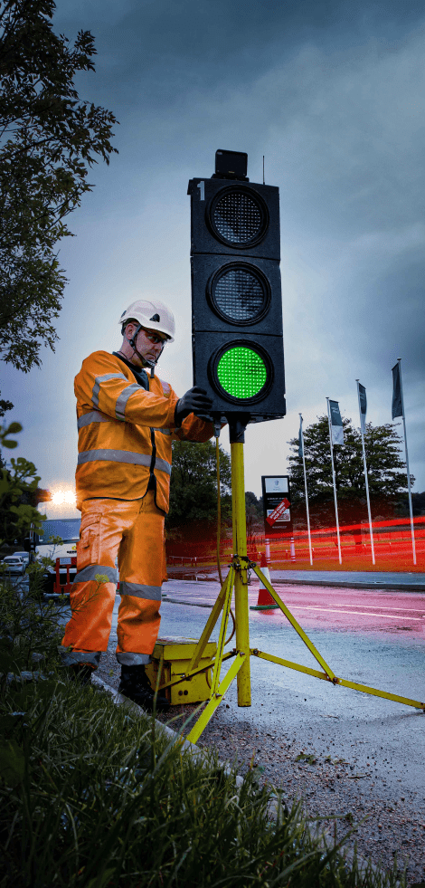 Man with temporary traffic light as part of our traffic management division